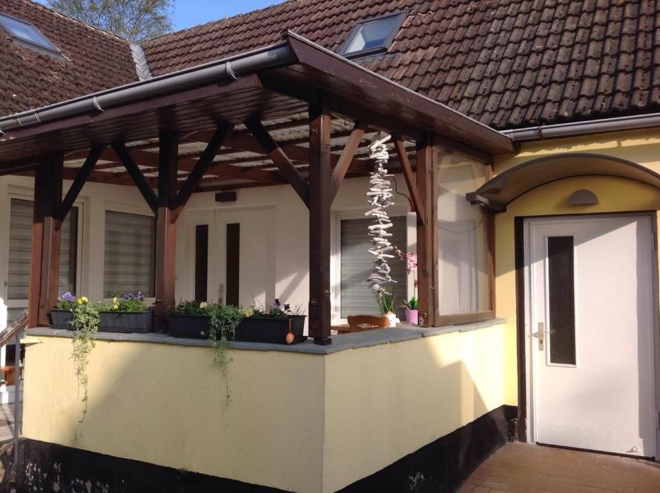 a house with a covered porch with plants on it at Haus Irma in Zingst