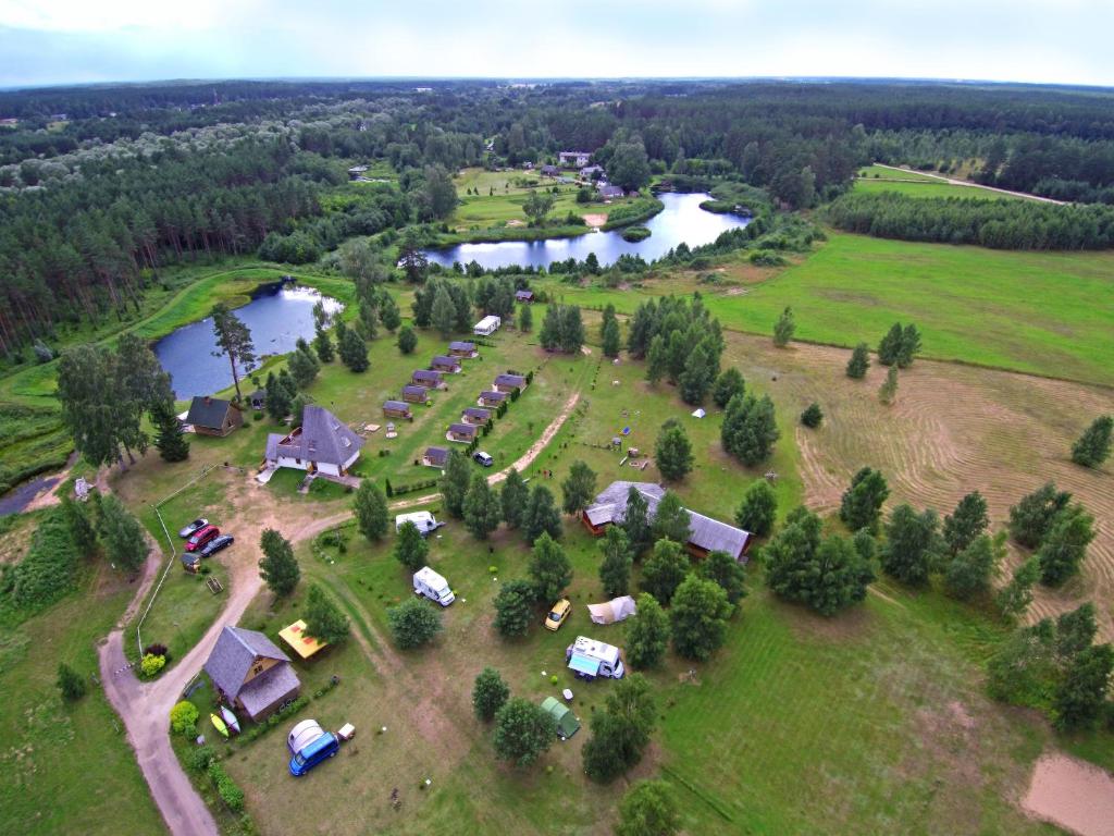 an aerial view of a farm with a house and a lake at Campsite Leiputrija in Ādaži