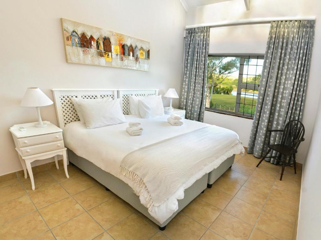 a bedroom with a large bed and a window at Addo River-View Lodge in Colchester