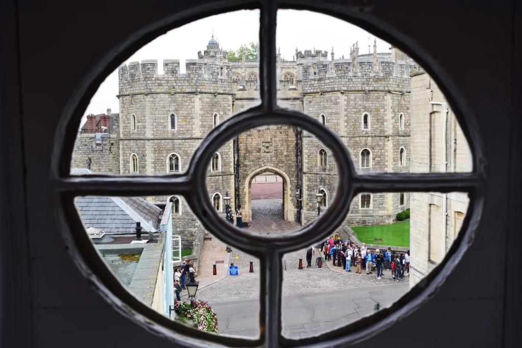 a view of a castle seen through a window at Castle Properties: The Sovereign 5 Bed Town House in Windsor