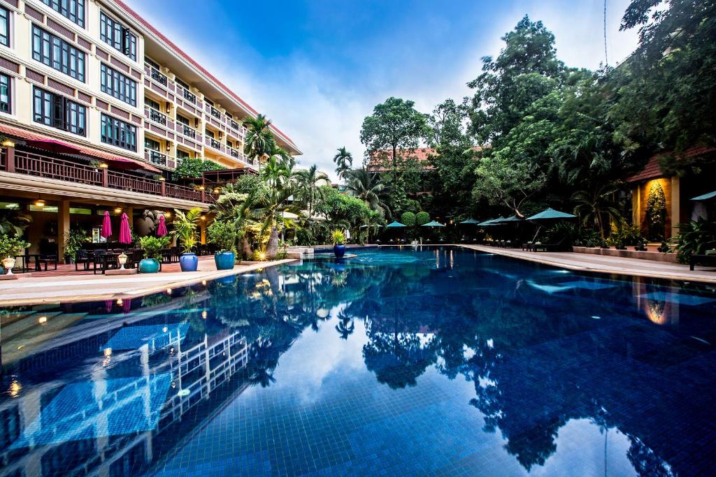 a swimming pool in front of a building at Prince Angkor Hotel & Spa in Siem Reap