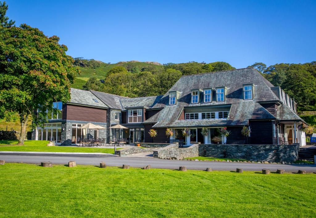 a large house with blue windows on a street at Glaramara Hotel in Borrowdale Valley