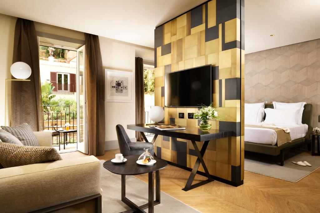 a hotel room with a bed and a desk at Margutta 19 - Small Luxury Hotels of the World in Rome