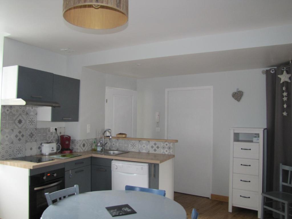 a kitchen with a table and a counter top at Appartement de charme à la montagne in Ax-les-Thermes