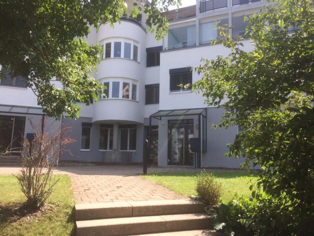 a white building with the front door open at Happiness in Sirnach