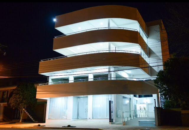 ein großes Gebäude in der Nacht mit eingeschaltetem Licht in der Unterkunft Hotel Vizzion in Paraí