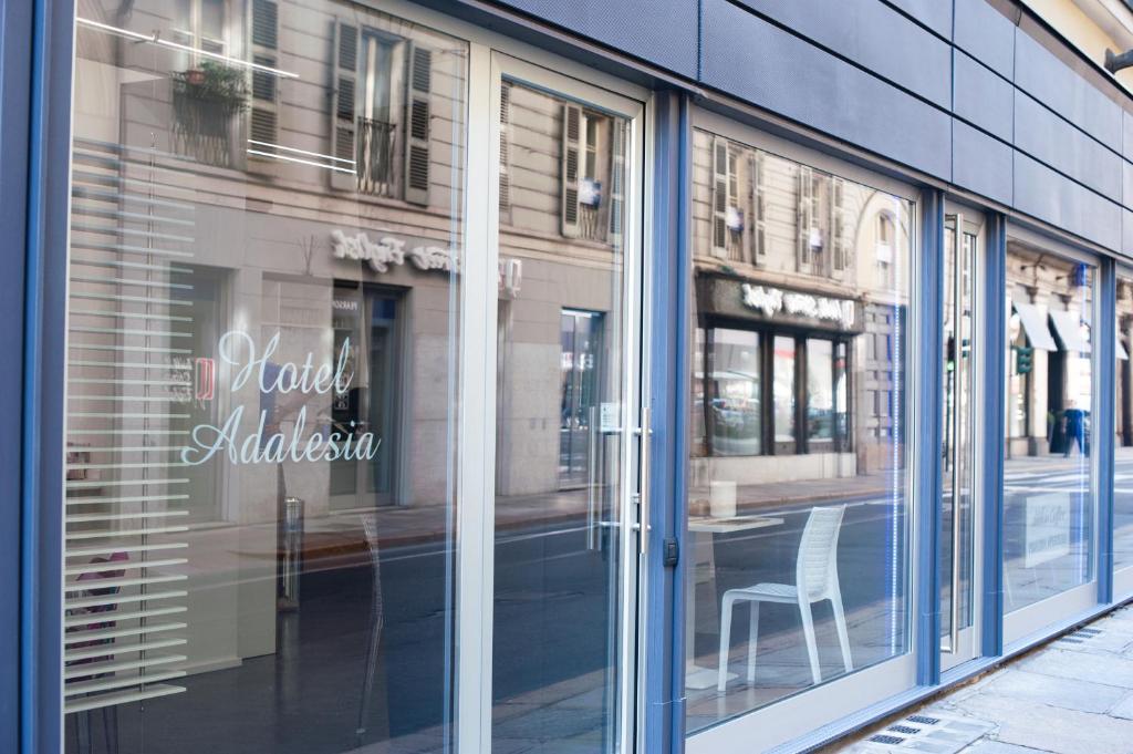 a window of a store with a chair in it at Adalesia Hotel & Coffee in Turin