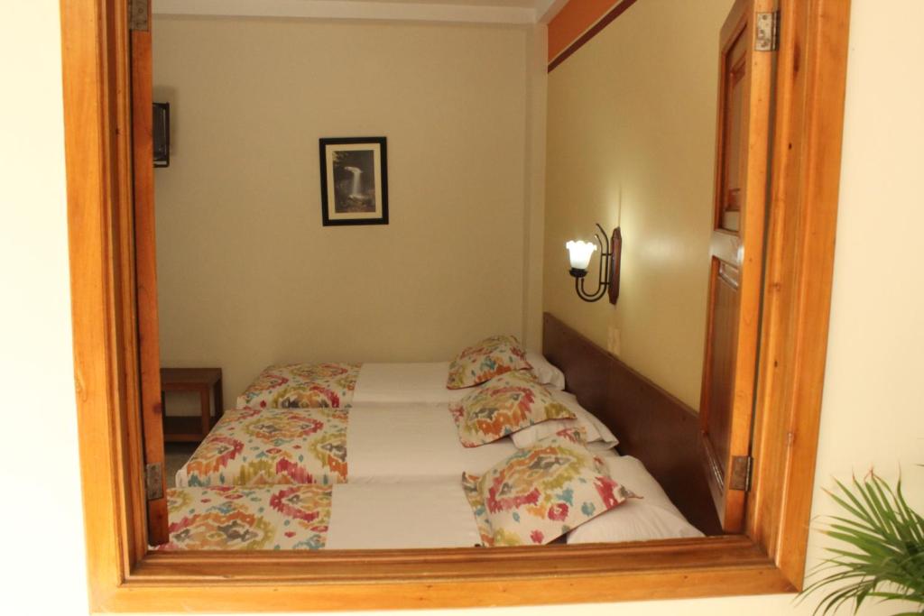 Postel nebo postele na pokoji v ubytování Hotel Valdivia Plaza