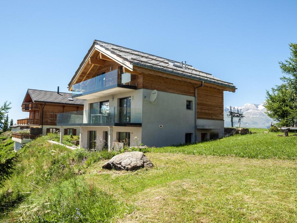 a house on top of a hill with a rock at Chalet Avista in Rosswald