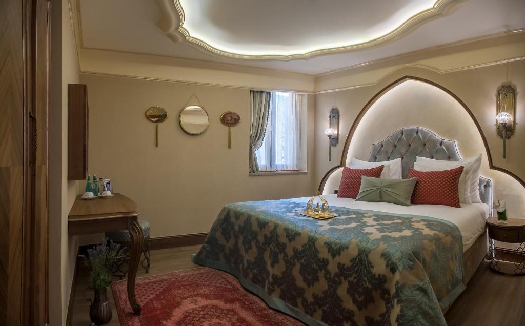 a bedroom with a bed with an arched headboard at Romance Istanbul Hotel Boutique Class in Istanbul