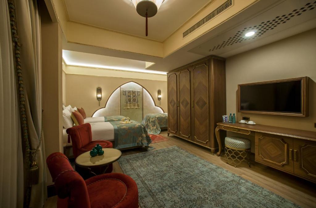 a hotel room with a bed and a flat screen tv at Romance Istanbul Hotel Boutique Class in Istanbul