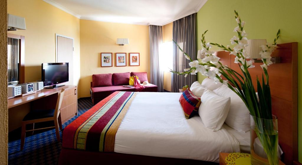 Postel nebo postele na pokoji v ubytování Prima Music Hotel