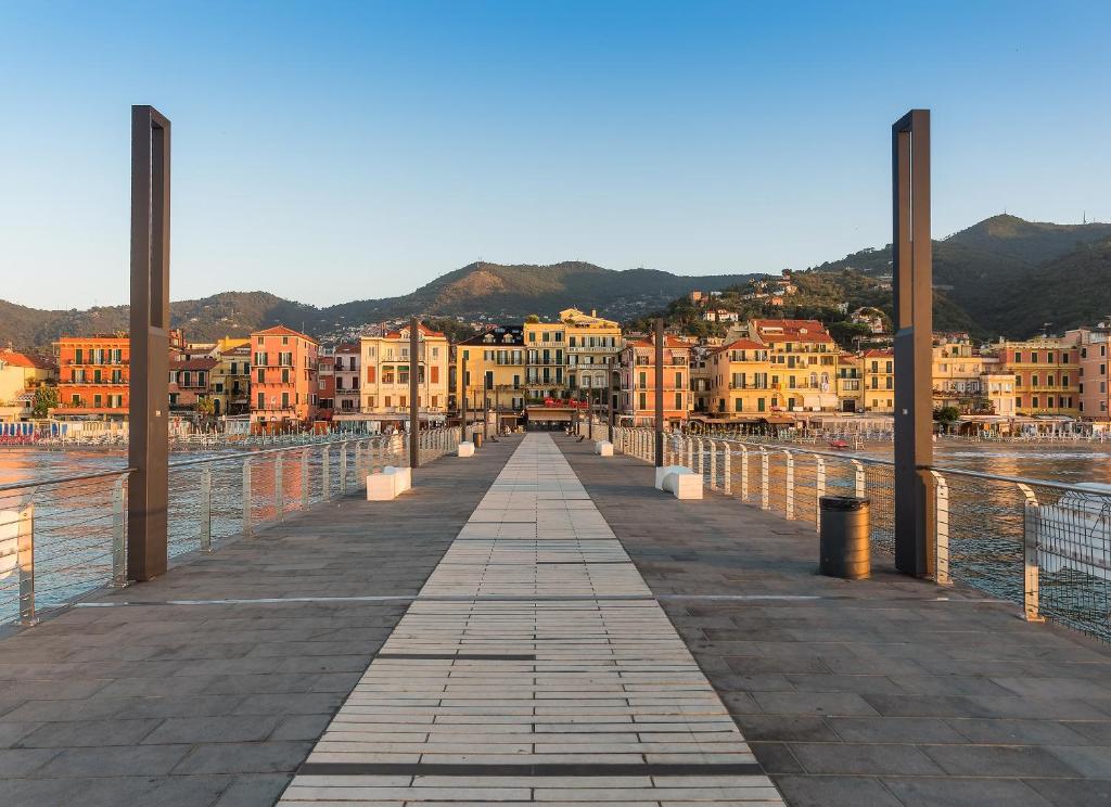 a bridge over a body of water with buildings at Hotel Ligure in Alassio