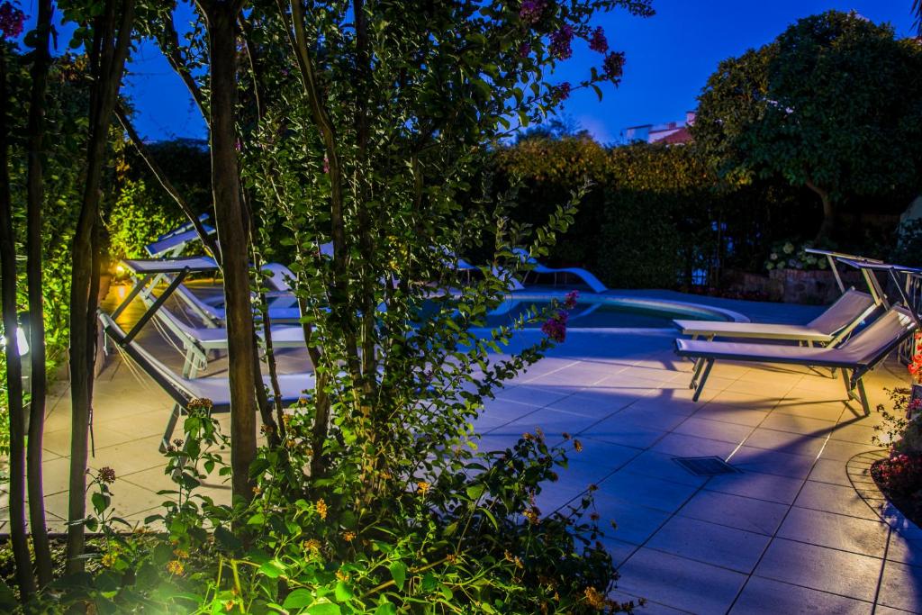 a couple of chairs sitting on a patio at night at VILLA MARYLU' in Ischia Town