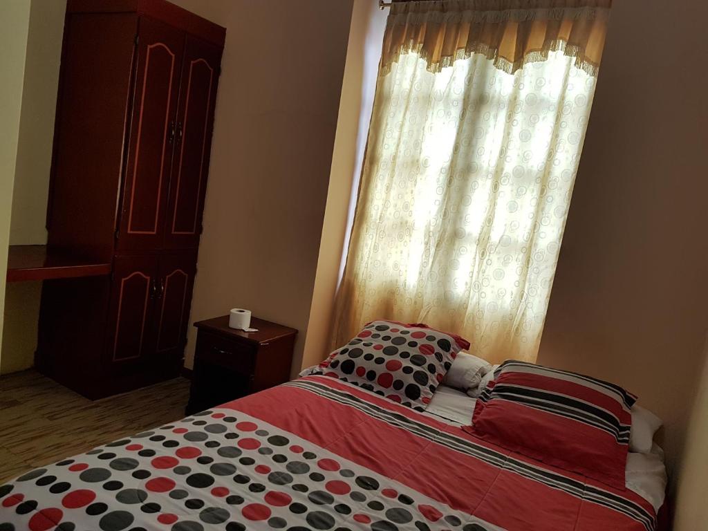 Postel nebo postele na pokoji v ubytování Hostal Buenos Aires