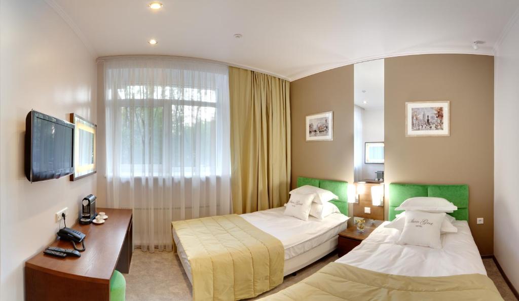 Postel nebo postele na pokoji v ubytování StanGret Hotel