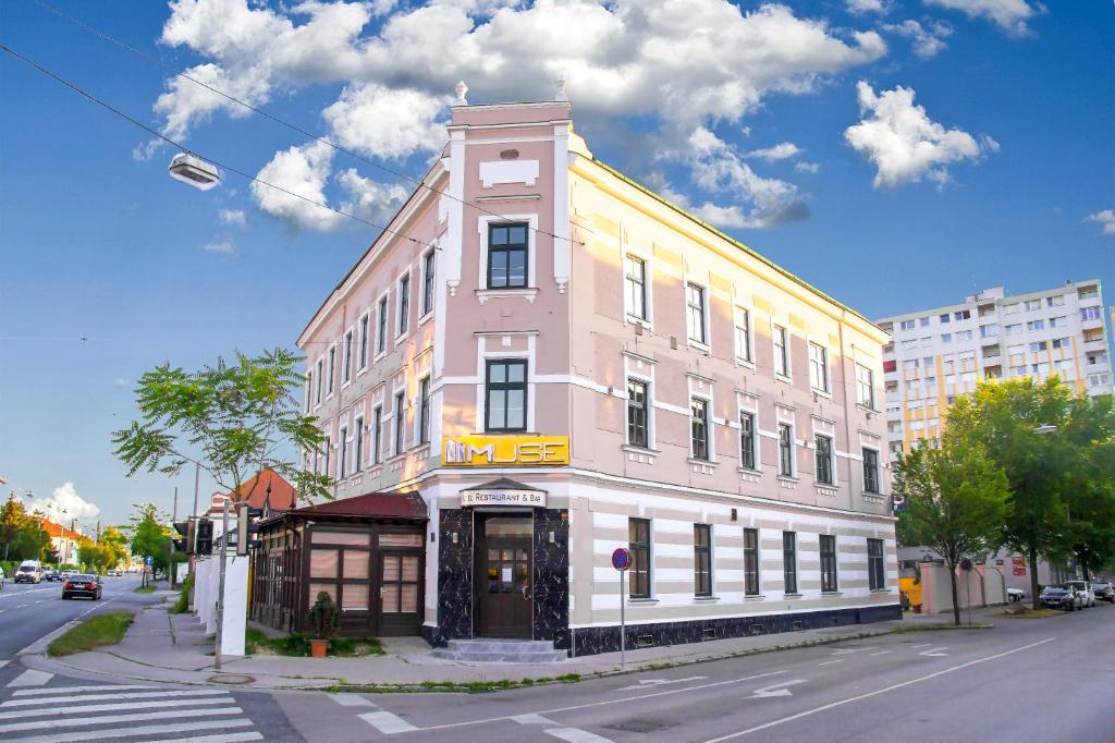 a pink building on the corner of a street at Hotel MUSE in Sankt Pölten