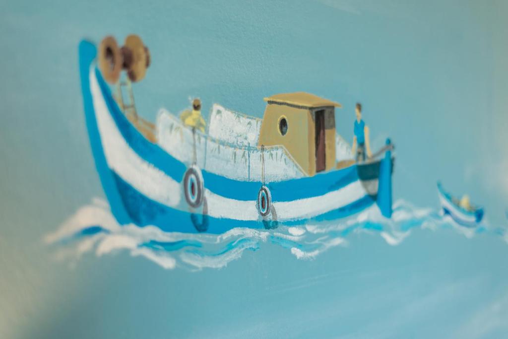 a cake with a boat in the water at Sofia's Lovely Rooms in Hora Sfakion
