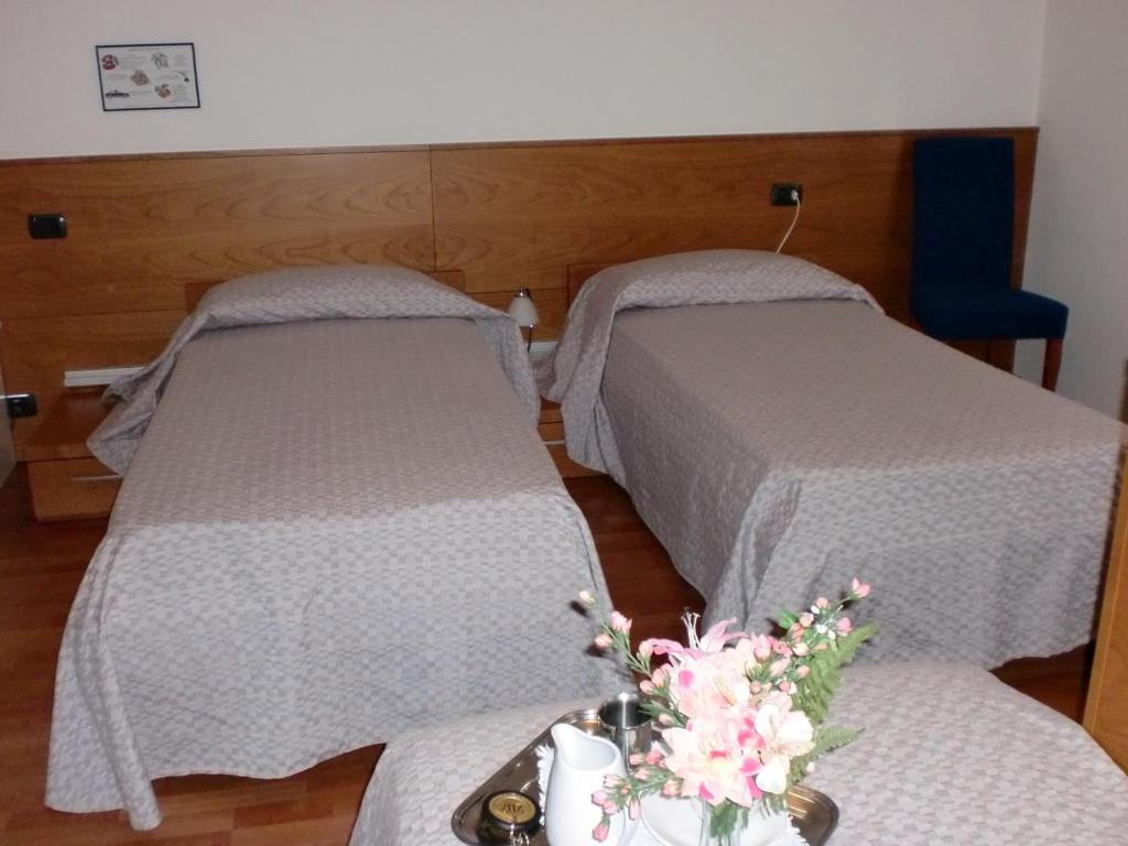 Postel nebo postele na pokoji v ubytování Rometta Hotel