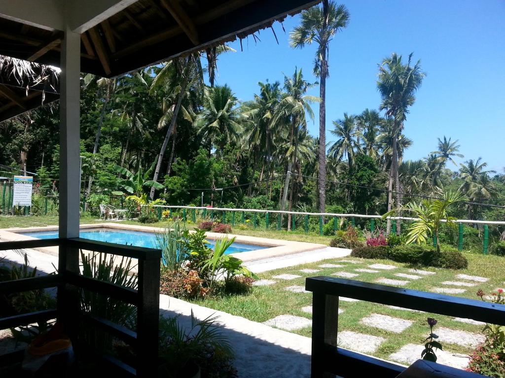 a view from the porch of a resort with a swimming pool at Dahilig Resort in Puerto Galera