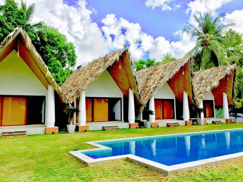 a resort with a swimming pool in front of it at Airport Resort in Katunayake