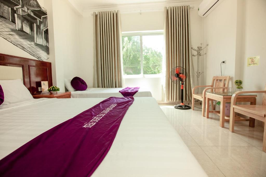 Postel nebo postele na pokoji v ubytování Dang Quang Guesthouse