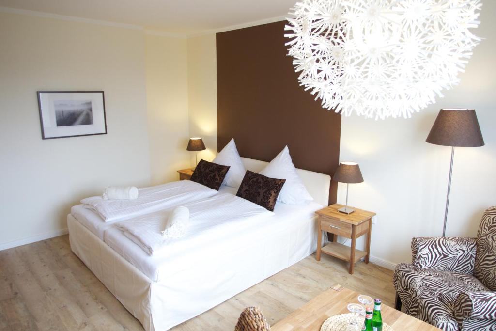Postel nebo postele na pokoji v ubytování Das Frühstückshotel Sankt Peter-Ording