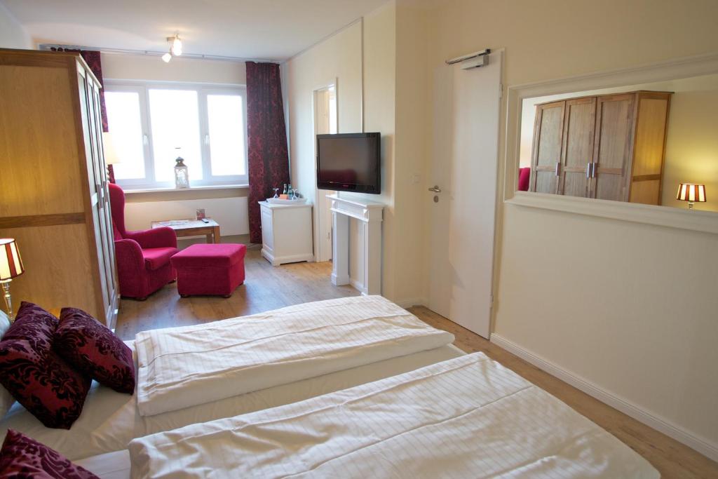 Postel nebo postele na pokoji v ubytování Das Frühstückshotel Sankt Peter-Ording