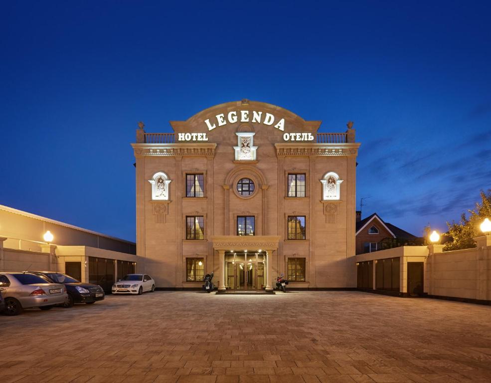 a building with a parking lot in front of it at Hotel Legenda in Rostov on Don