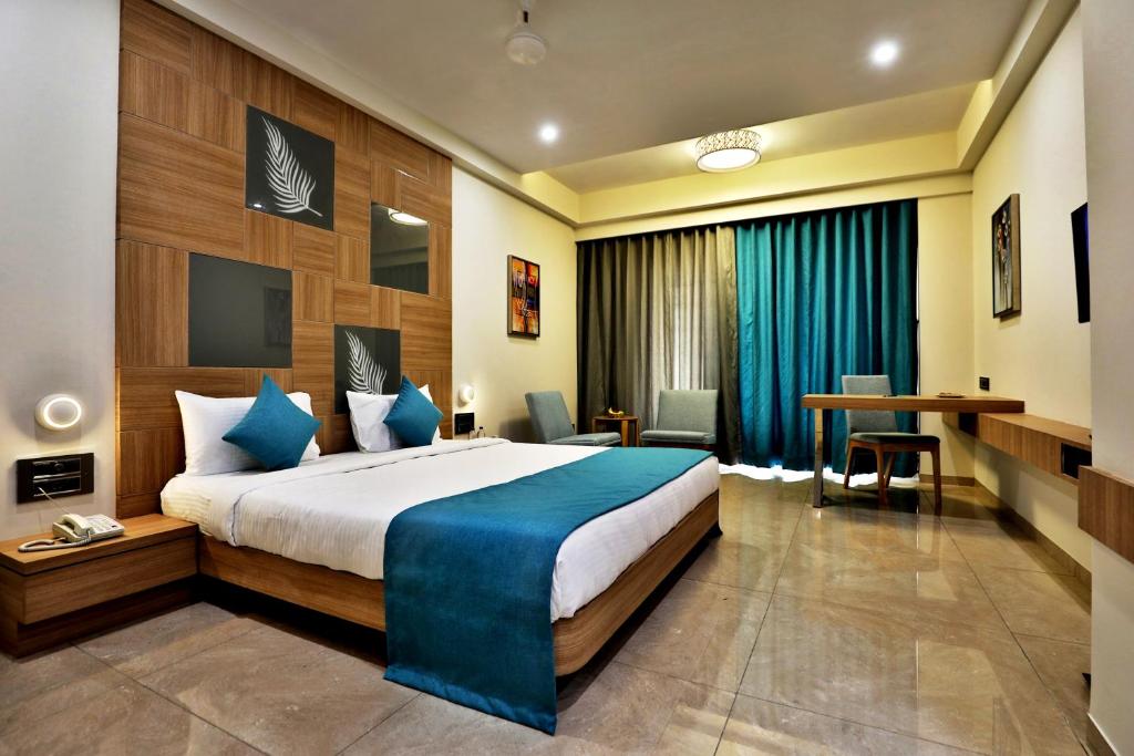 a hotel room with a bed and a desk at VITS Devbhumi, Dwarka in Dwarka
