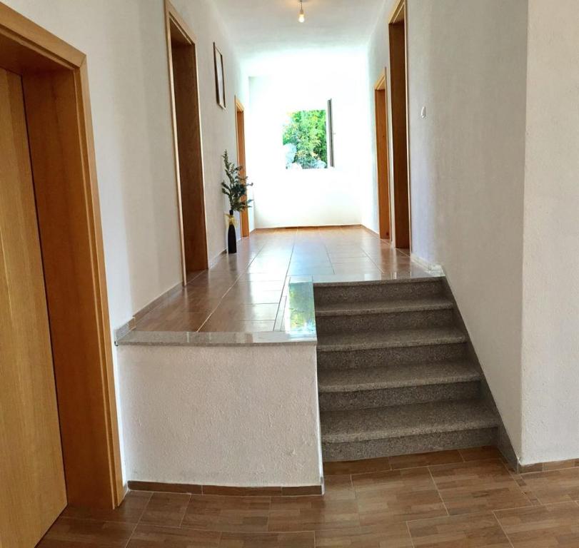 a hallway with a staircase in a house at Guesthouse Soče in Međugorje
