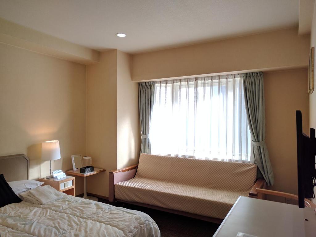 Postel nebo postele na pokoji v ubytování Hotel Harbour Yokosuka