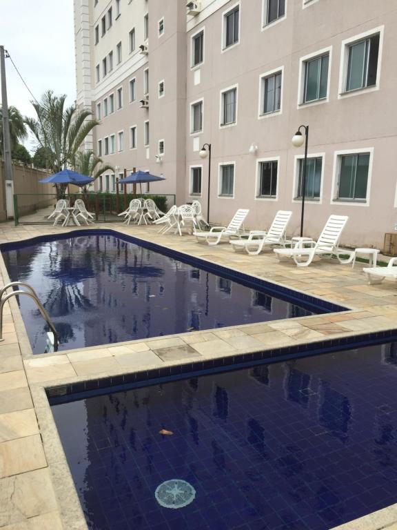 a swimming pool in front of a building at Spazio Solarium - Apartamento in Lauro de Freitas