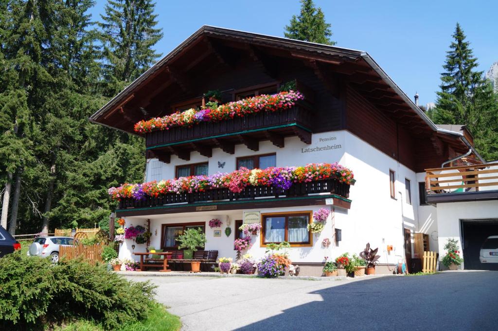 a building with flowers on the side of it at Haus Latschenheim in Ramsau am Dachstein