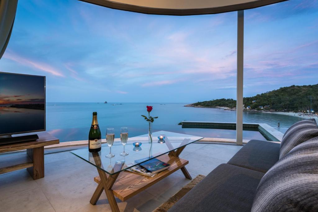 a living room with a view of the ocean at Villa Callisto in Thong Son Beach