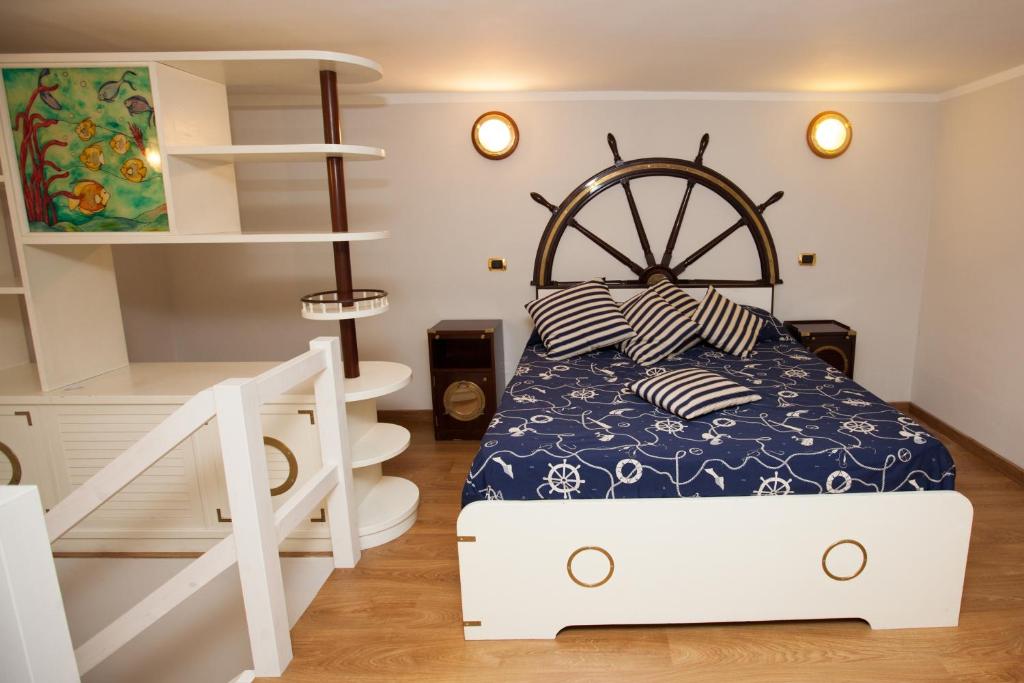 a small bedroom with a bed and a staircase at Hotel Ausonia in Naples