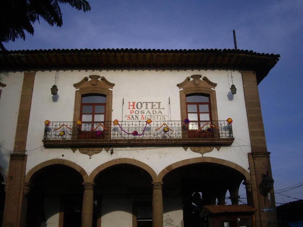 a building with a balcony with a hotel sign on it at Posada de San Agustin in Pátzcuaro