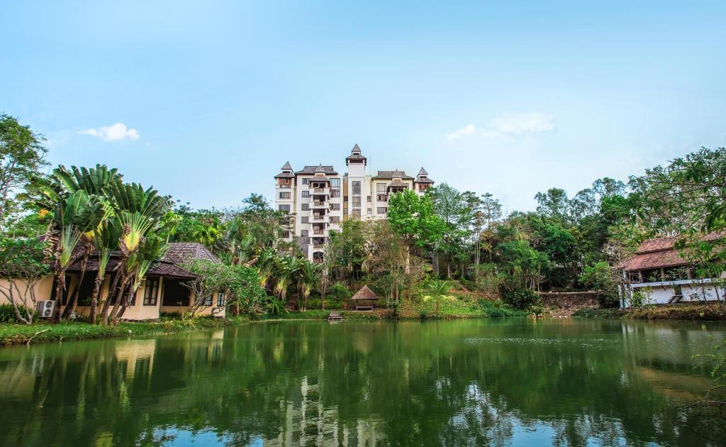 a view of a river with a building in the background at Jirung Health Village in Mae Rim