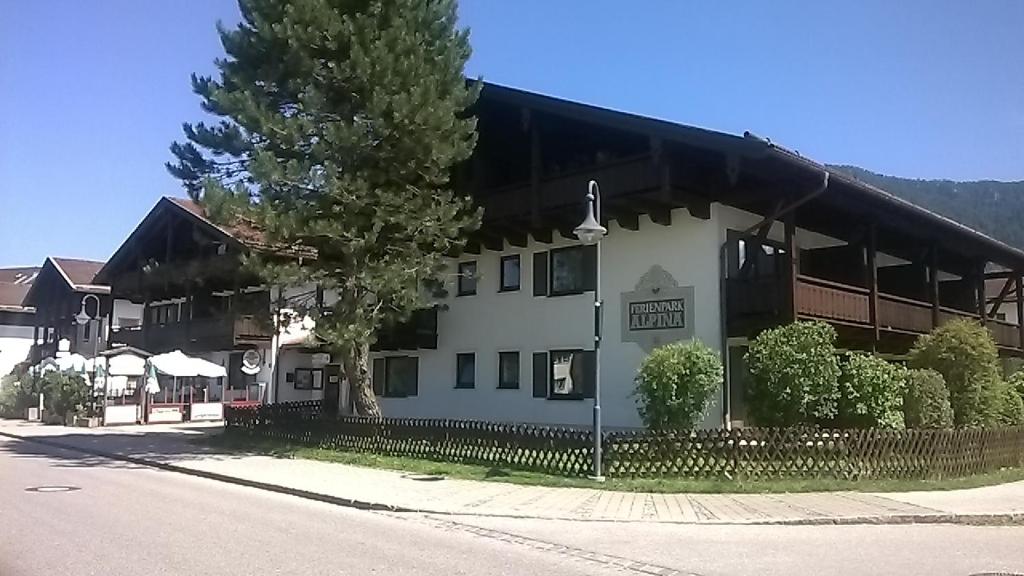 um grande edifício branco com uma árvore em frente em Alpina Inzell 223 Chiemgaukarte em Inzell