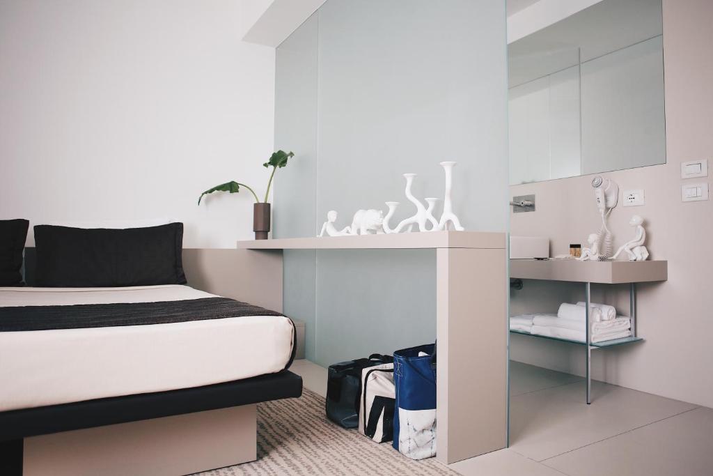 Postel nebo postele na pokoji v ubytování Le Nove Hotel