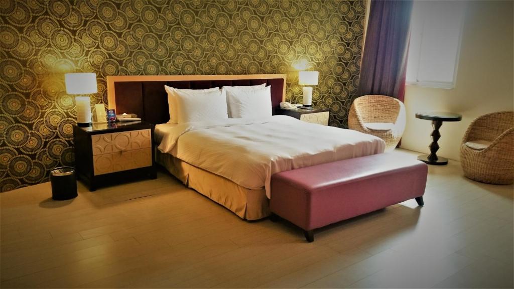 Postel nebo postele na pokoji v ubytování Her Home Spa Motel Xinying