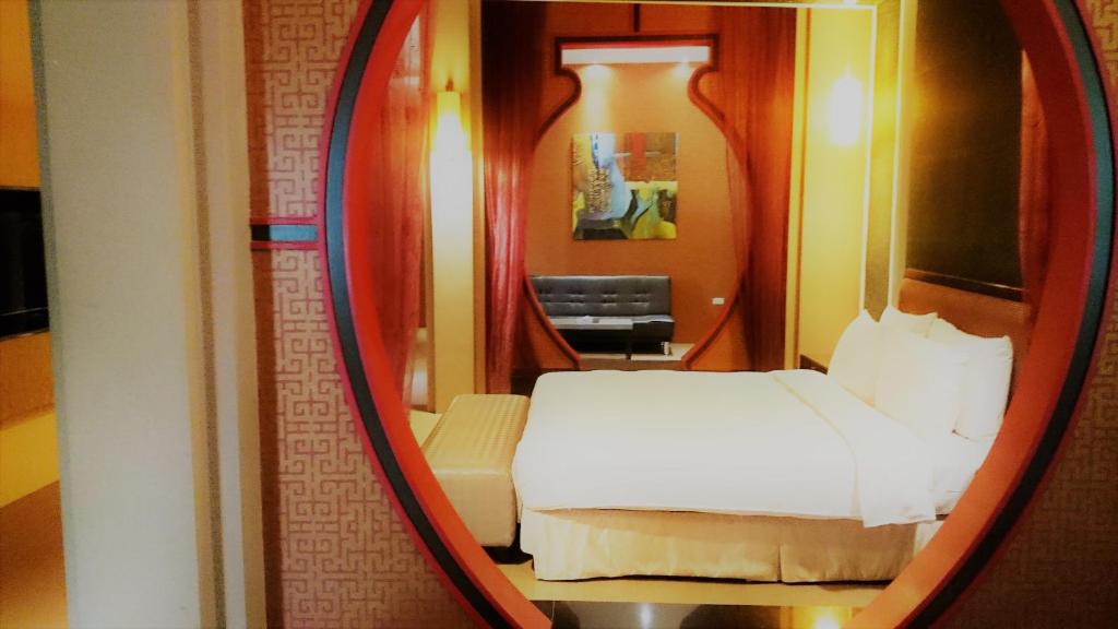 Postel nebo postele na pokoji v ubytování Her Home Spa Motel Xinying