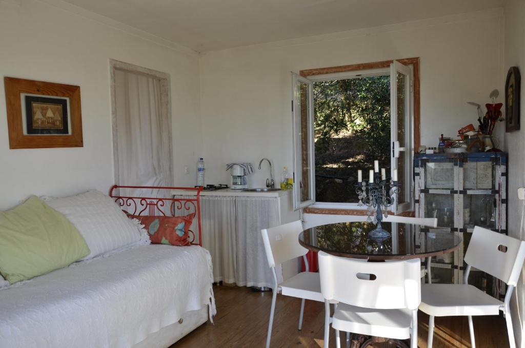 a bedroom with a bed and a table and chairs at Ha Mar ao Luar in Setúbal