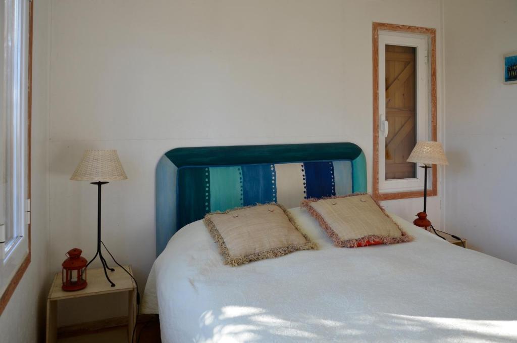 a bedroom with a bed with two pillows on it at Ha Mar ao Luar in Setúbal