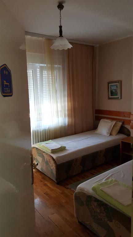 Postel nebo postele na pokoji v ubytování Guest House Major