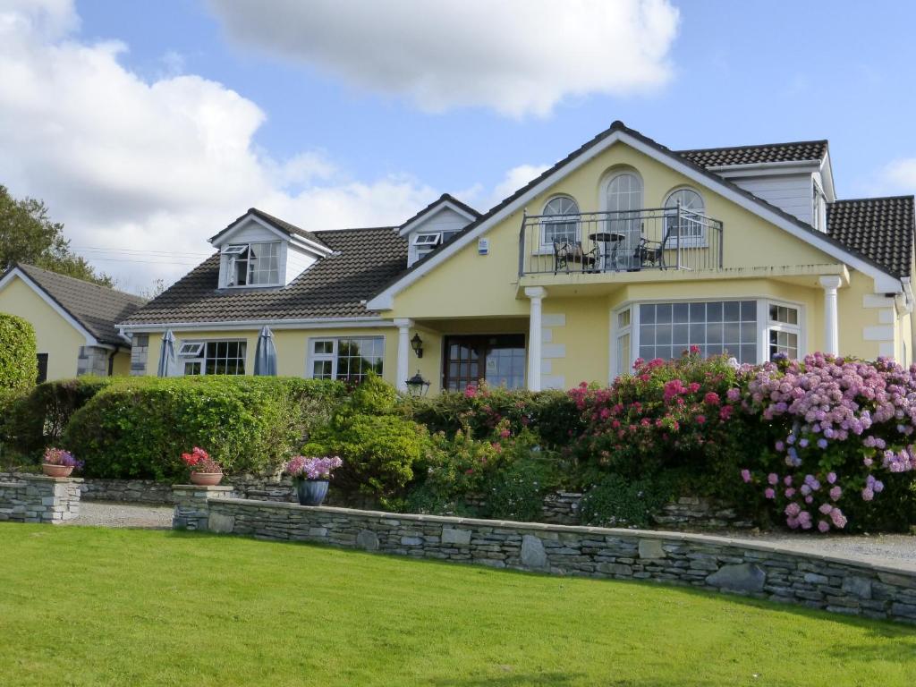 a house with flowers in the front yard at Oakfield in Kenmare