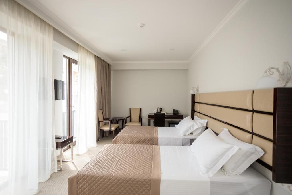 Postel nebo postele na pokoji v ubytování Hotel Genio