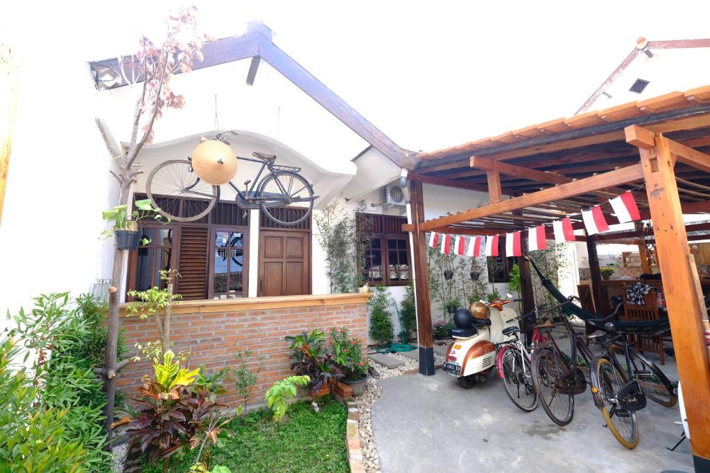 a house with bikes parked outside of it at Wood Stone in Yogyakarta