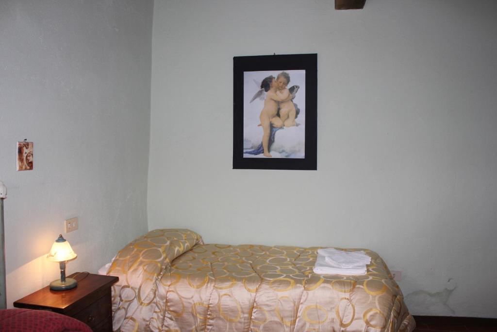 Postel nebo postele na pokoji v ubytování Badia il Vingone