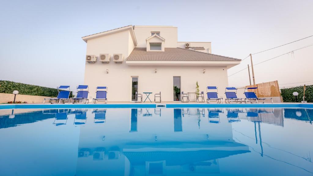 a villa with a swimming pool in front of a house at Villa Patrizia Selinunte in Marinella di Selinunte